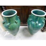 Pair of Persian Green Glazed Wine Vessels, each with four handles, approx. 75cms high
