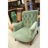 Late 19th / Early 20th century Green Upholstered Button Back Armchair raised on turned legs and