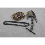 Victorian amethyst pinchbeck brooch, three oval mixed cut set amongst scrolling vine leaves,