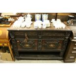 Late 19th century Heavily Carved Oak Buffet Sideboard comprising Two Brush Slides over Two