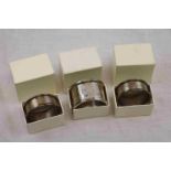 Pair of silver napkin rings, engine turned decoration with blank rectangular cartouches, makers