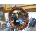 Wooden framed bevelled glass circular Mirror with carved Bird decoration