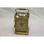 Brass chiming carriage clock, cream enamel dial with gilt centre, black Arabic numerals and black