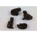 Four carved hardwood netsukes comprising a cat, dog and puppy, frogs in a barrel and a tortoise (4)