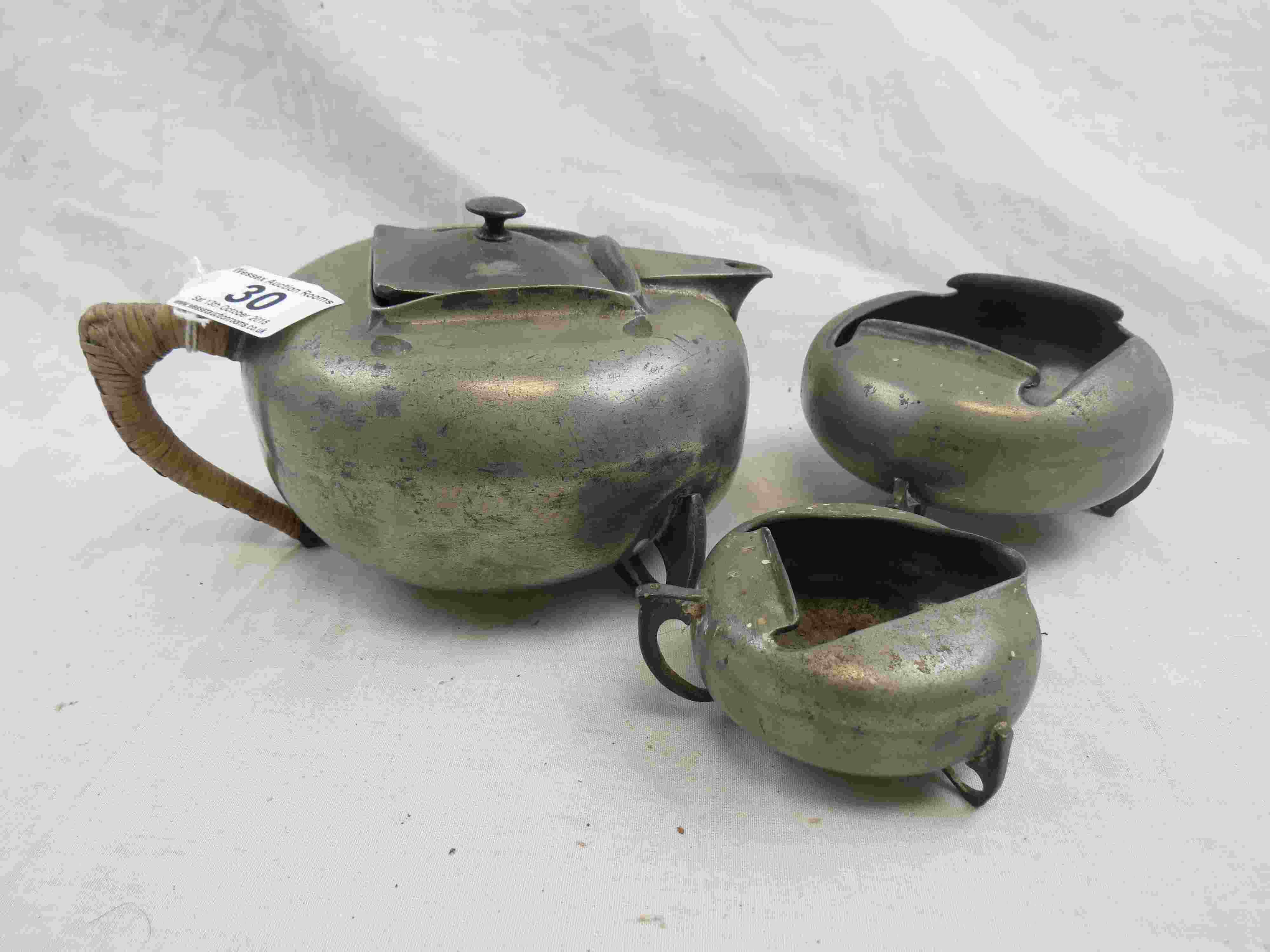 Archibald Knox for Liberty & Co Tudric pewter three piece tea service comprising teapot, sugar