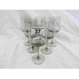 Six circa 1960s smokey glass small wine glasses, height approximately 14.5cm