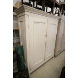 19th century Cream Painted Pine Wardrobe, the double doors opening to reveal hanging space with