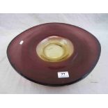 Large studio glass dish of asymmetric elliptical form, amethyst glass with yellow glass centre,