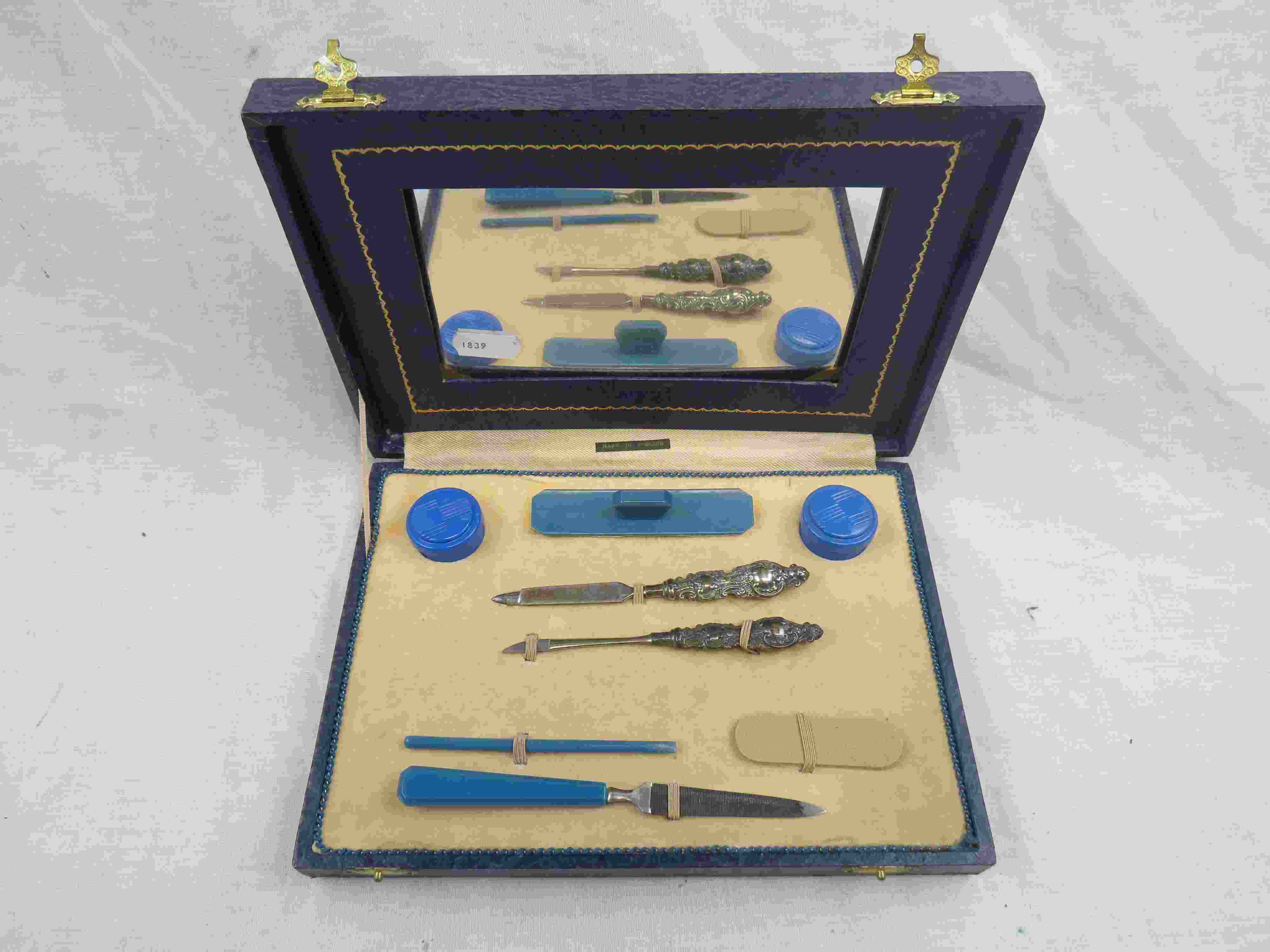 Cased Art Deco Bakelite travel manicure set, repousse silver handles hallmarked Levi & Salaman,