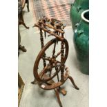 Swiss Turned Wooden Spinning Wheel with Ivory Mounts and raised on four wooden deer hoof feet, 90cms