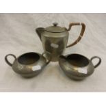 Tudric hammered pewter three piece part tea set, 01537, comprising hot water pot, milk jug and