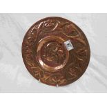 Brass Arts and Crafts circular dish, repousse and chased decoration, two exotic birds to centre,