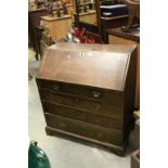 Georgian Oak Bureau with Four Drawers and raised on bracket feet