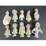 Ten Continental ceramic pin cushion heads modelled as woman, hand painted (10)