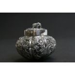 White metal tea caddy of gourd form, repousse jungle scene decoration depicting lions, elephants,