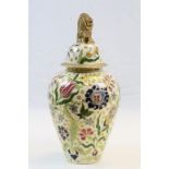 Ceramic Urn with Floral decoration & gilt detailing and Lion finial to lid, base marked "
