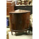 Early 20th century Walnut Corner Cabinet with twin opening doors and raised on square legs with