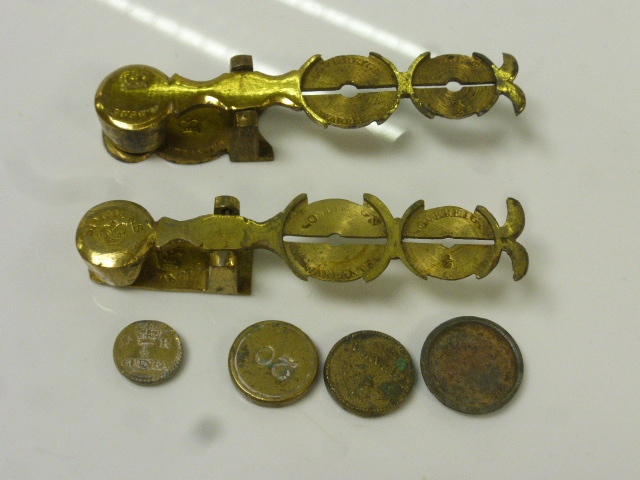 Two pairs of Victorian brass sovereign scales together with weights