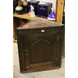 Georgian Oak Hanging Corner Cabinet, the single panel door opening to reveal three shaped shelves