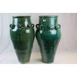 Two large Green glazed Persian Wine vessels with loops to the side