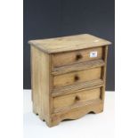 Wooden collectors cabinet with three drawers