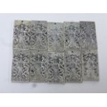 Ten Chinese white metal rectangular tokens, character marks and dragon decoration, pierced hole to