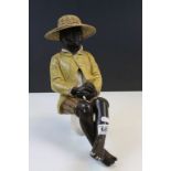 Painted plaster seated African/ American boy