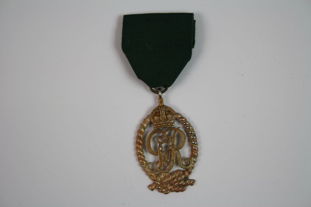 A Royal Navy Reserve Officers Decoration Medal, An Oval Silver Gilt Medal Formed By The Royal Cypher