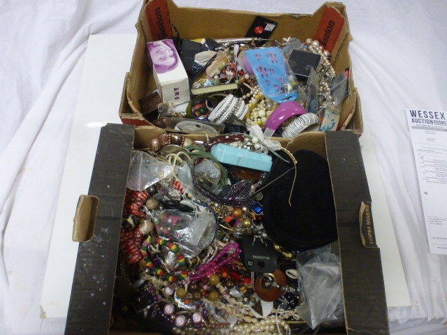 Two boxes of assorted costume jewellery to include necklaces, bracelets, bangles, earrings etc
