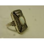 Synthetic opal, marcasite and black onyx white metal ring, central oval cabochon cut synthetic