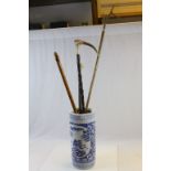 Four vintage walking sticks to include Antler handled and a Ceramic stick stand with Oriental