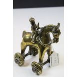 Middle Eastern polished bronze child's toy of seated warrior on a horse, short tail, decorative