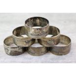 Six Chinese white metal napkin rings with oriental river scenes and Chinese character marks, width