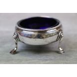 George III open silver salt cellar, cauldron form raised on three hoof feet, crimped rim, blue glass