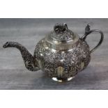 White metal Indian teapot of melon shape form, heavy repousse decoration to include animals, Elders,