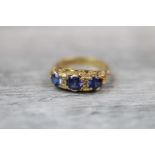 Victorian blue sapphire three stone 18ct yellow gold ring, three round mixed cut blue sapphires, the