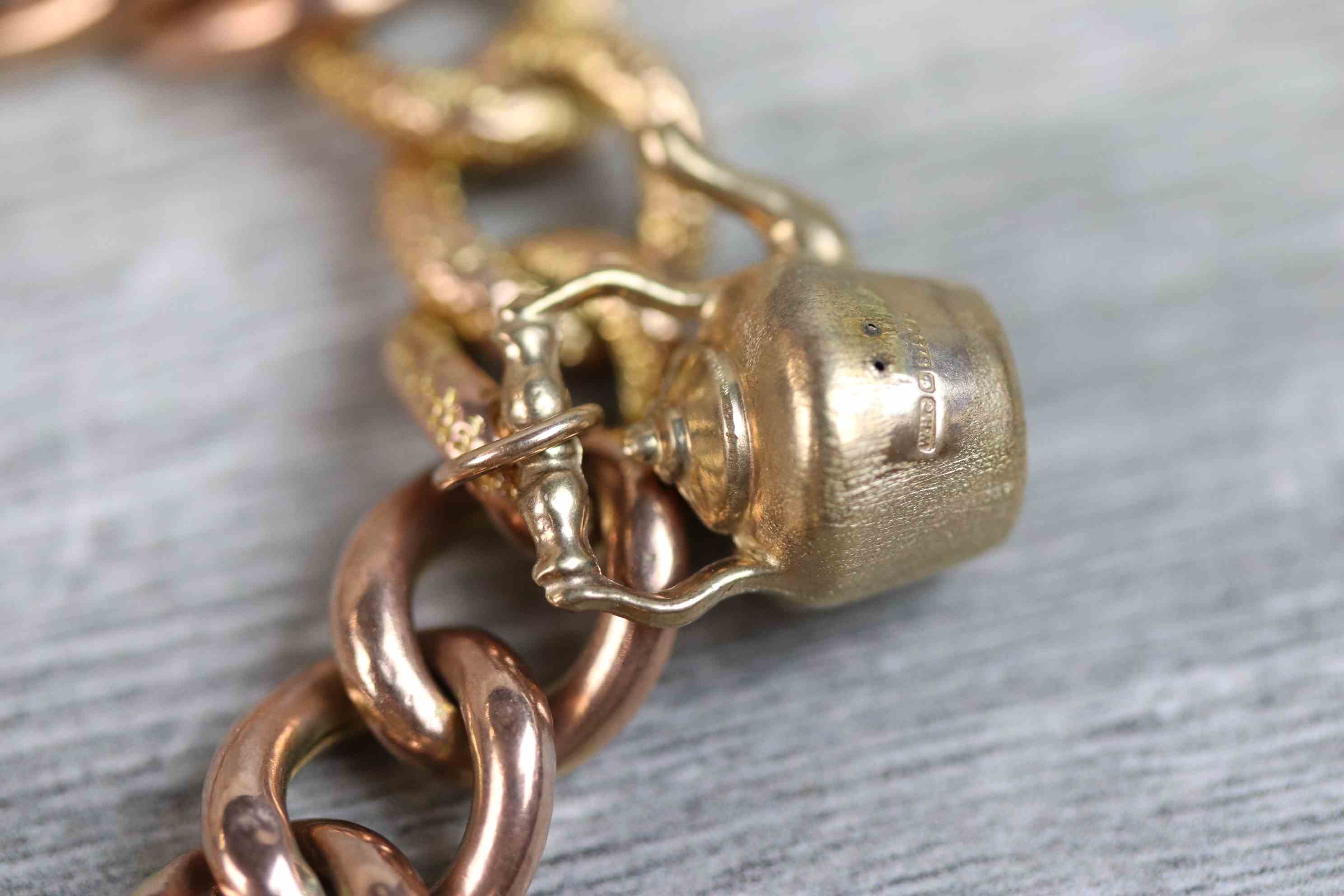 9ct rose gold curb link charm bracelet with 9ct rose gold padlock clasp, seven 9ct gold and yellow - Image 9 of 10