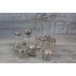Collection of various silver topped cut glass dressing table jars and scent bottles, to include