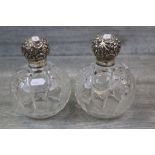 Pair of large Late Victorian silver topped cut glass display scent bottles, the hinged silver lid