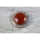 1960s Scottish carnelian silver target brooch, the circular cabochon cut collet set carnelian