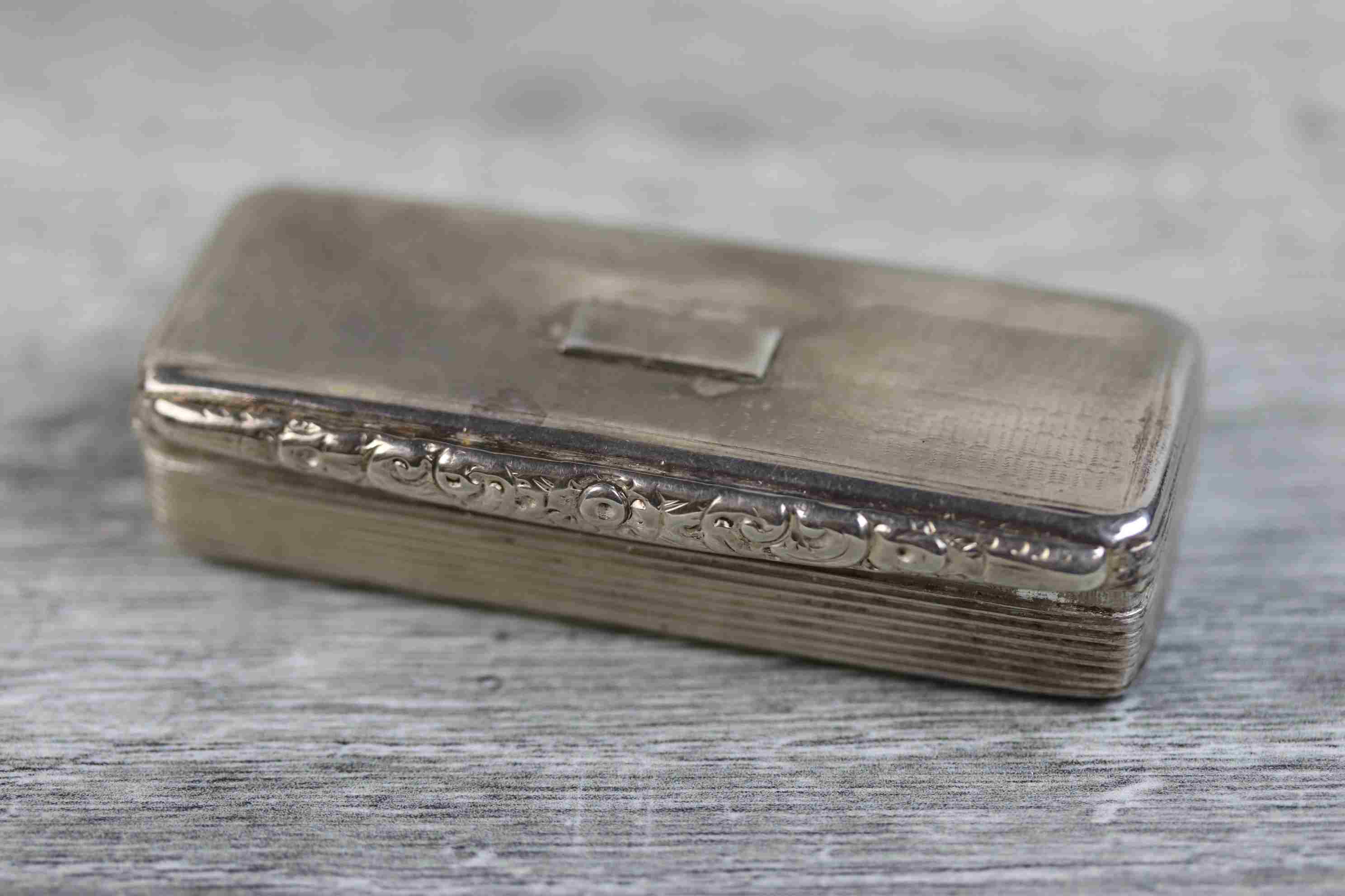 George IV silver snuff box of elongated rectangular form, blank cartouche to hinged lid, rubbed