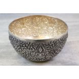 Large white metal bowl, repousse foliate scroll and floral decoration with four deity figures, the