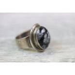 Carl Ove Frydensberg: a Danish modernist snowflake obsidian silver ring, the oval cabochon cut stone