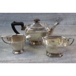 George VI three piece silver tea service comprising teapot, sugar bowl and milk jug, rectangular