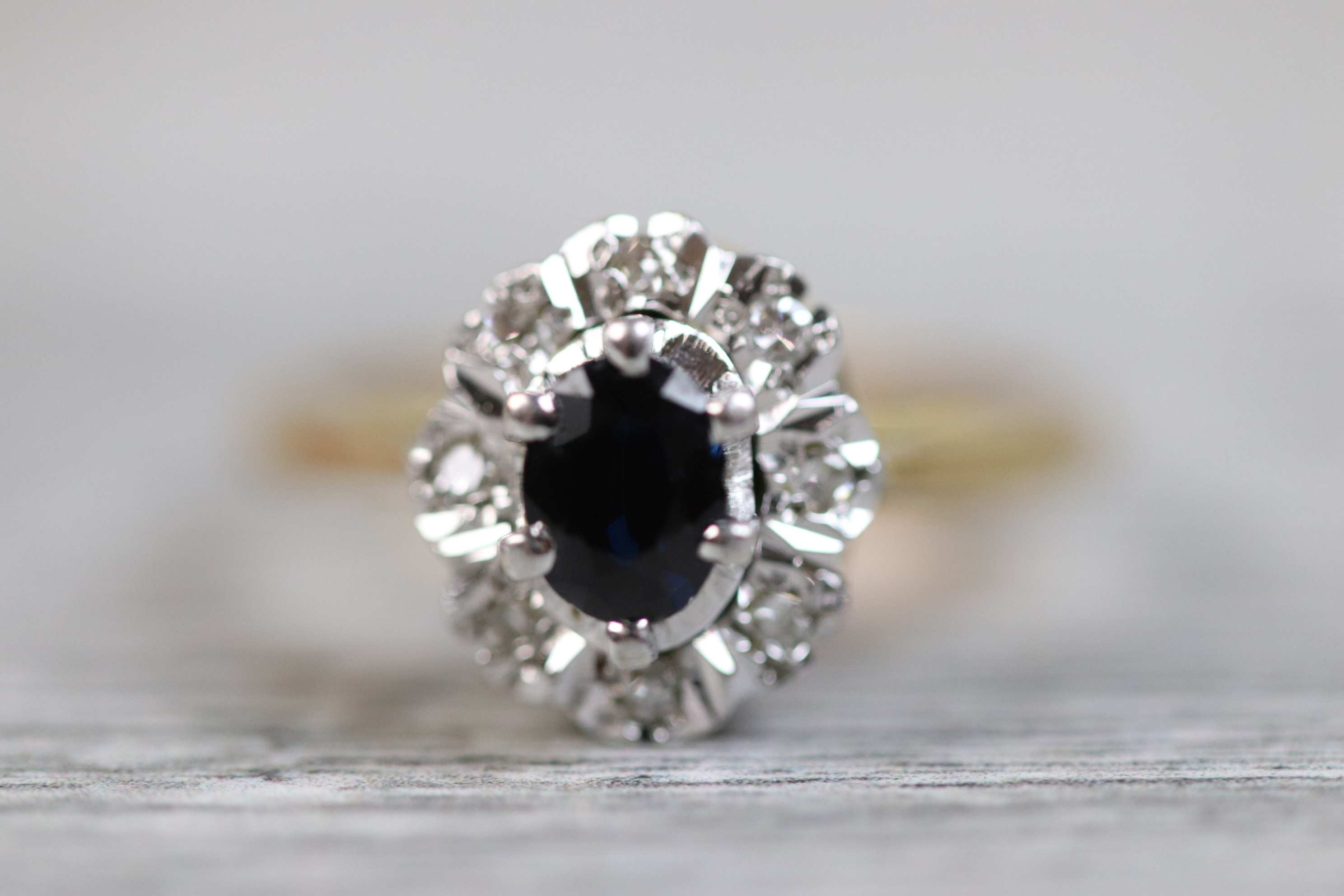 Sapphire and diamond 18ct yellow gold and white gold set cluster ring, the central blue-black oval - Image 2 of 6