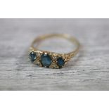 Blue topaz and diamond 9ct yellow gold Victorian style boat head dress ring, three graduated oval