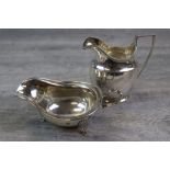 Edwardian silver cream jug, plain form with ribbed detailing to rim, angular handle, monogrammed,