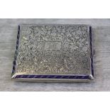 Enamelled silver cigarette case, chased floral and foliate decoration with blue enamelled border,