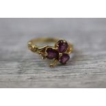 Purple stone shamrock yellow metal ring