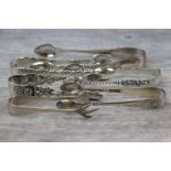 Six pairs of assorted silver sugar tongs, to include shell and scroll design in relief, Josiah